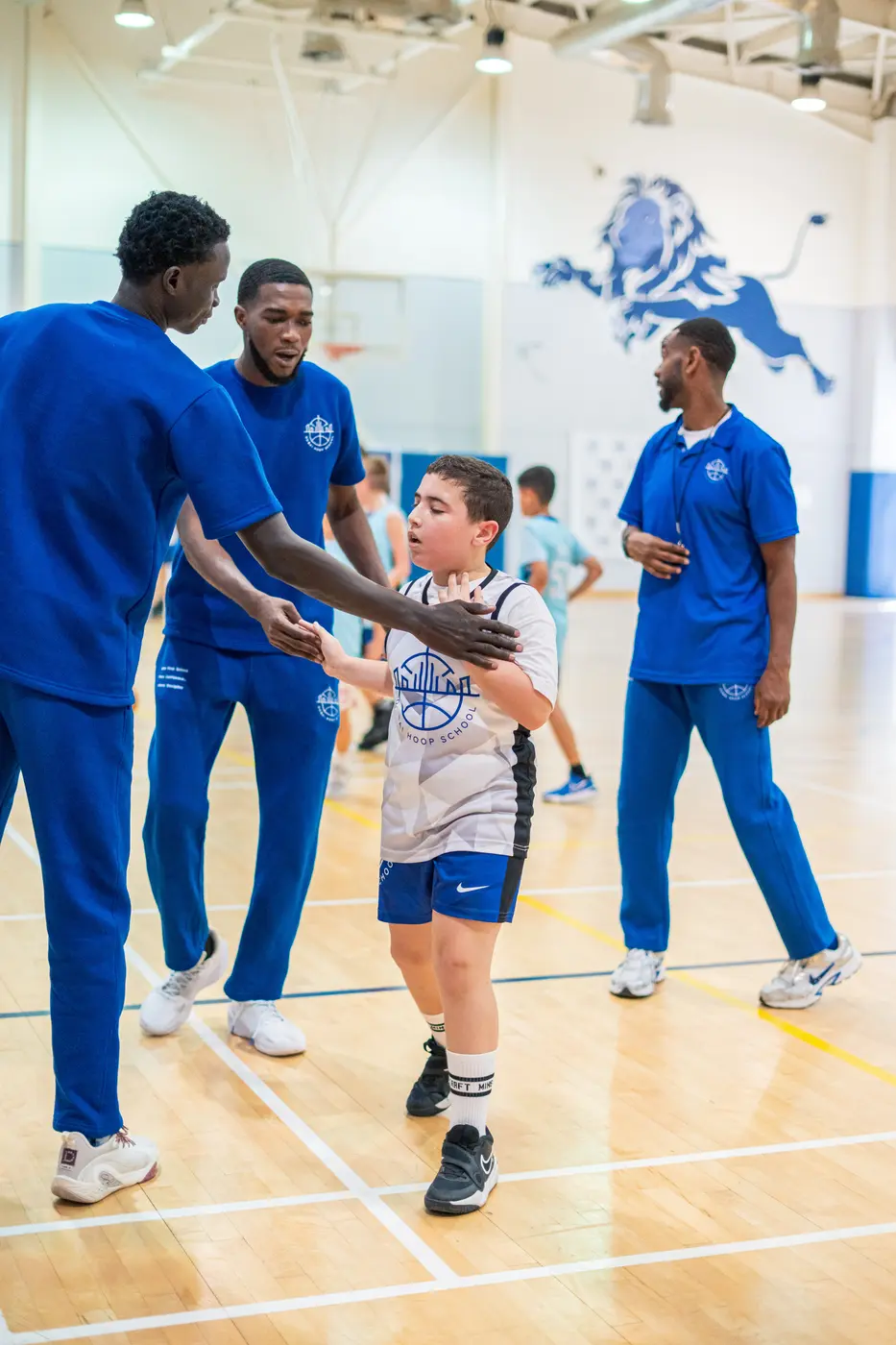 Dubai Hoop School coaches encouraging a young player